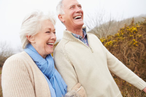 Senior Couple Walking Through Winter Countryside